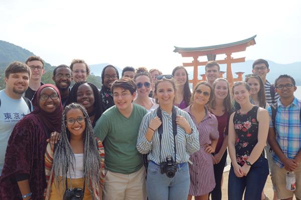A group of students stand in front of a torii during their study abroad course in Japan in May 2018
