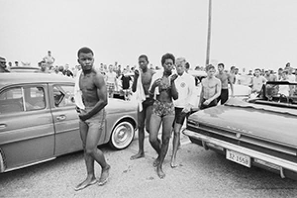 A jeering crowd follows three Black youths in 1963 (Getty Images)