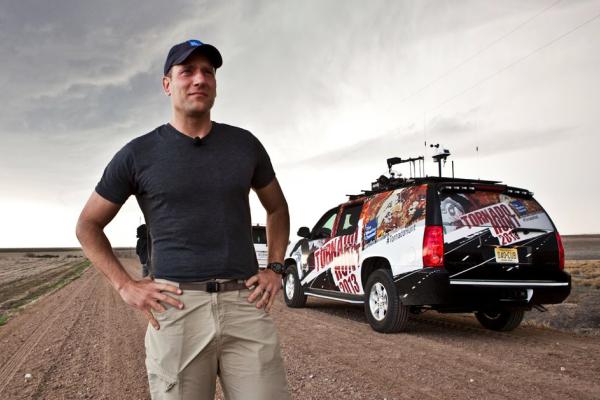 Mike Bettes looks at the sky in front of The Weather Channel Tornado Hunt vehicle