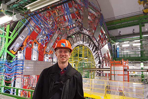 Tony Lefeld, a PhD candidate in the Department of Physics, stands in front of the CMS detector at the Large Hadron Collider at CERN in Geneva, Switzerland.