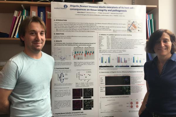 Adam Bercz stands with his principal investigator, Dr. Nathalie Sauvonnet, after preparing his poster