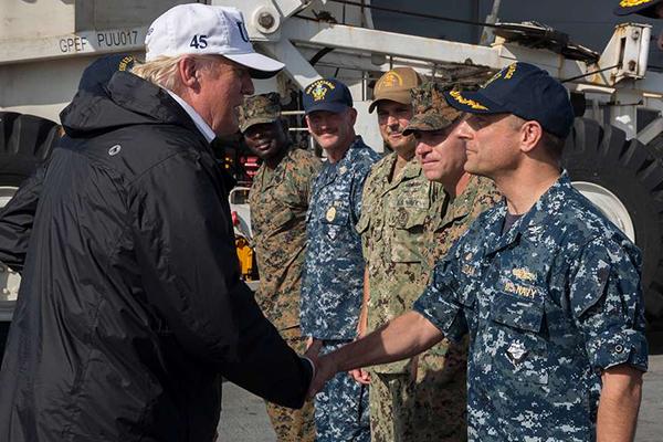 President Donald Trump shakes hands with Capt. David Guluzian of the U.S. Navy