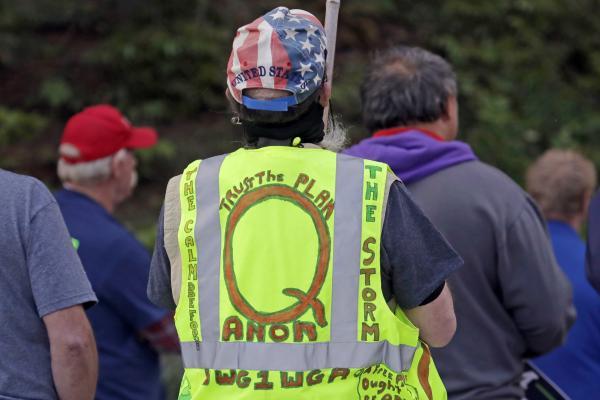 Man wearing q anon vest