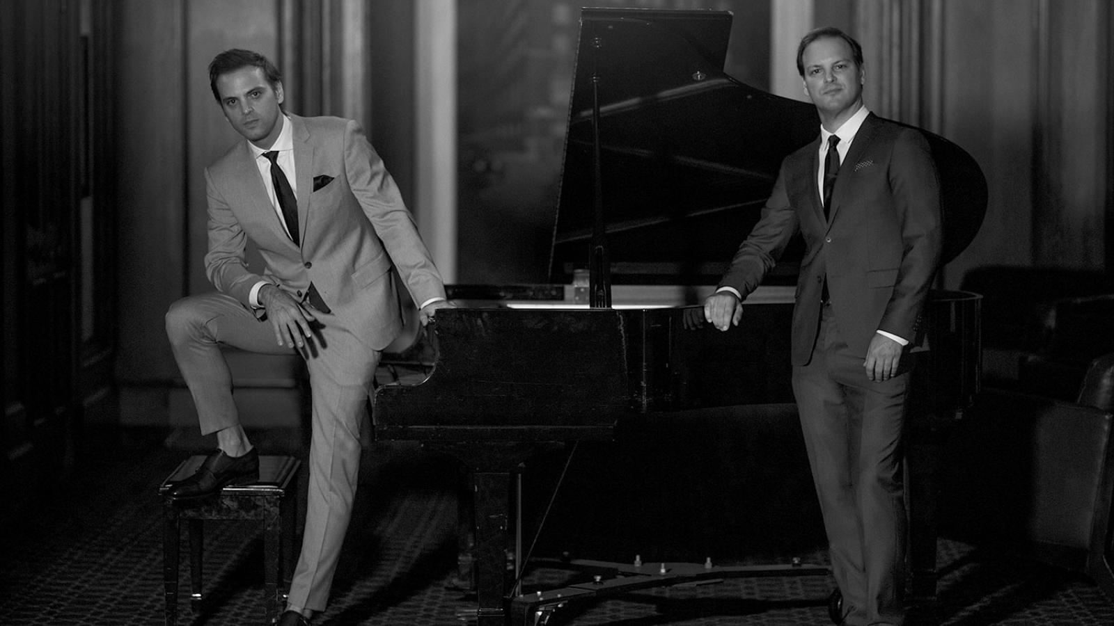 The Alonso Brothers posing with a grand piano