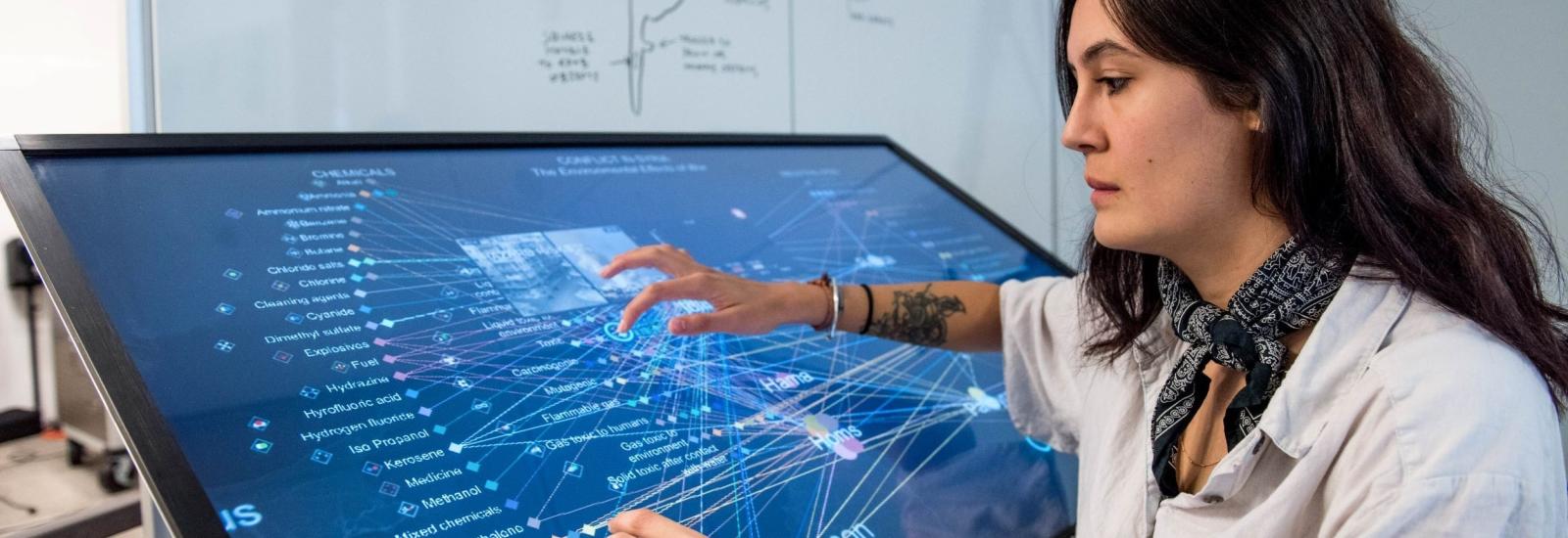 a researcher at a large computer screen