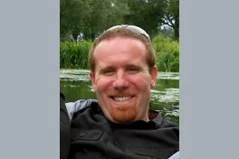 Headshot of Professor Matthew Sullivan in front of a body of water