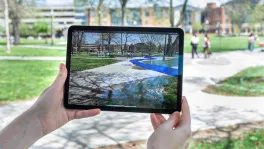 A tablet showing VR depictions of underground streams