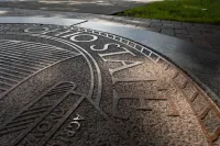 Outdoor architecture, design and branding details of The University Seal on The Oval.