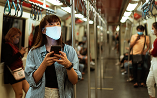 Woman wearing a face mask on the subway